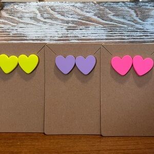 Colored heart shaped enamel earrings. Available in different colors